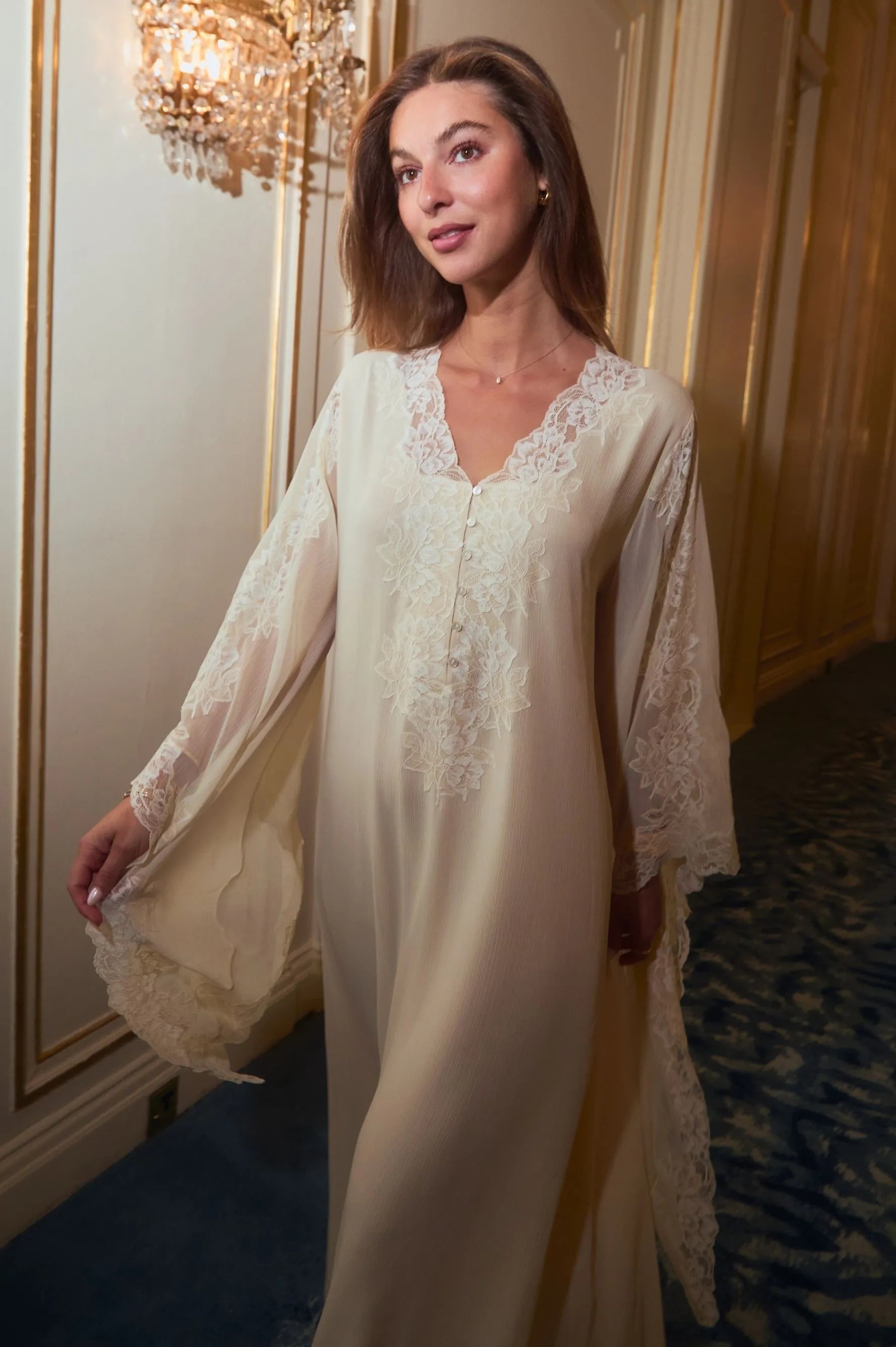 Side profile of Miel Gold chiffon maternity dress with triangle sleeve design