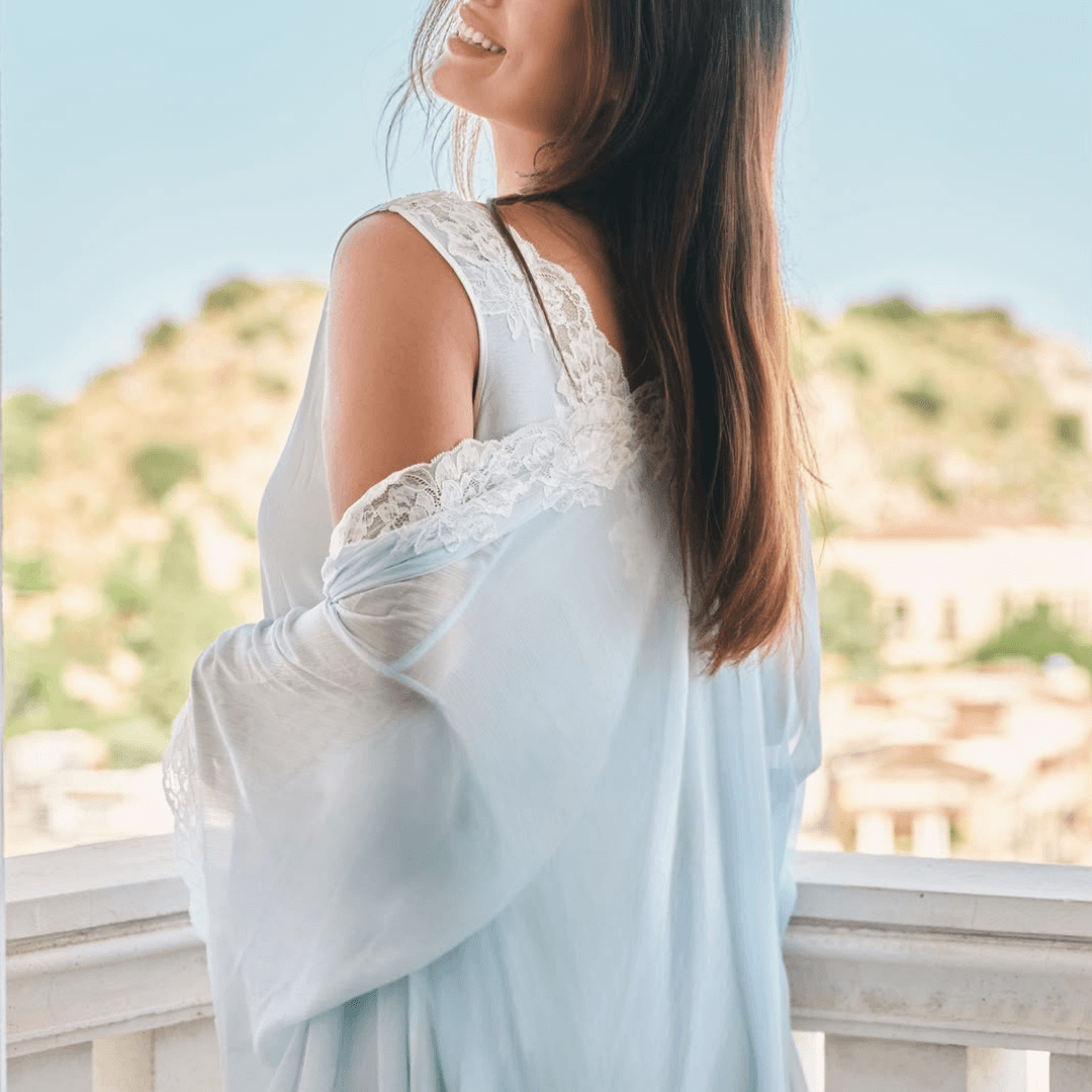 woman wearing lightweight silk chiffon robe with nightgown in a sunlit.