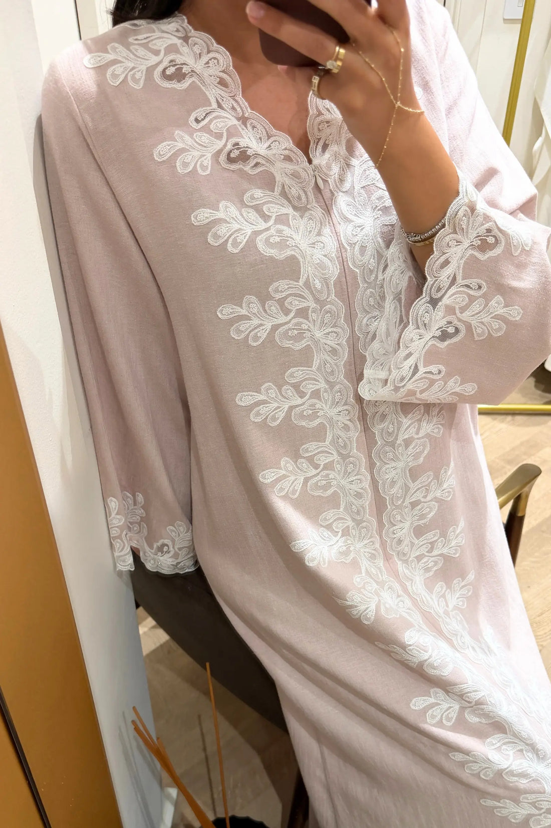 Powder outfit with white lace details worn by a model, standing against a neutral background.