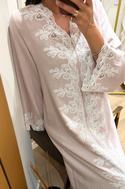 Powder outfit with white lace details worn by a model, standing against a neutral background.