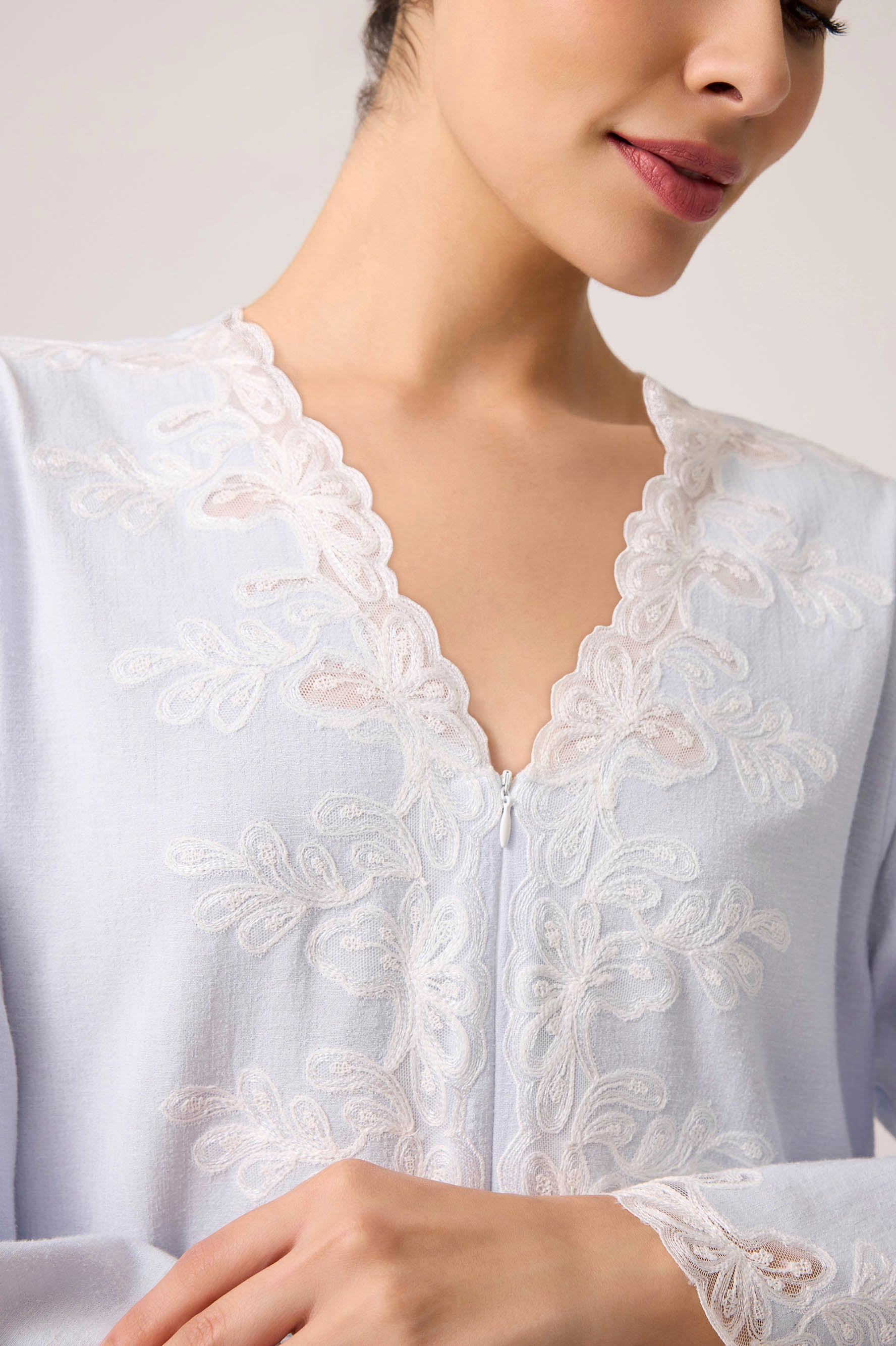 Close-up of a white embroidered blouse with a neutral background